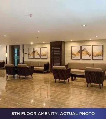 a lobby with chairs and couches in a building at 1 Bedroom with Balcony at Air Residences, Makati in Manila