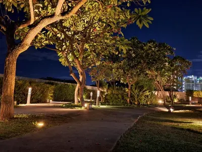 a park at night with trees and lights at ELUDE Designer Suite Pasig - Prime Location in Manila