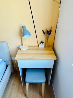 a desk with a lamp and a blue chair at Raven's Nest Cozy Condo with Netflix Wi-fi in Imus in Imus