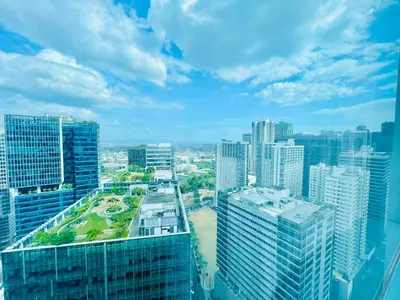an aerial view of a city with tall buildings at 1 Queen Bed & 2 double beds at One Uptown Residences with XBOX and Netflix in Manila