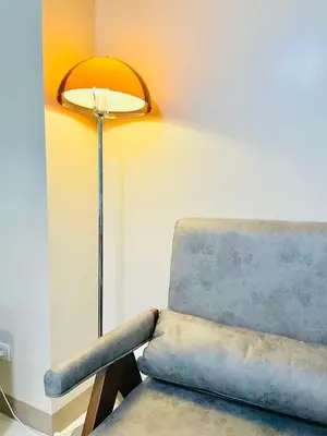 a chair and a lamp in a room at 1 Queen Bed & 2 double beds at One Uptown Residences with XBOX and Netflix in Manila