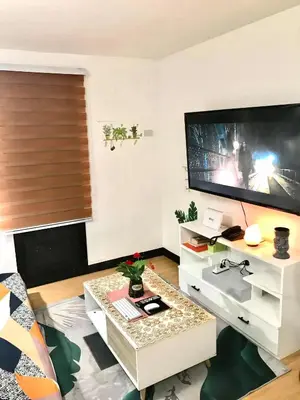a living room with a large flat screen tv at The Escape Pad 7 in Manila