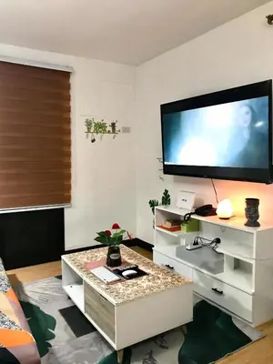 a living room with a large flat screen tv on the wall at The Escape Pad 7 in Manila