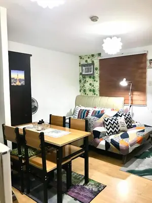 a living room with a table and a couch at The Escape Pad 7 in Manila
