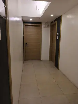 a hallway with two doors and a tile floor at Centro Tower - 2 Bedroom Fully Furnished in Manila