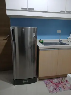 a kitchen with a stainless steel refrigerator next to a sink at Centro Tower - 2 Bedroom Fully Furnished in Manila