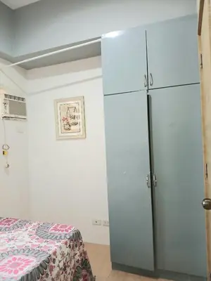 a bedroom with a refrigerator and a bed at Centro Tower - 2 Bedroom Fully Furnished in Manila