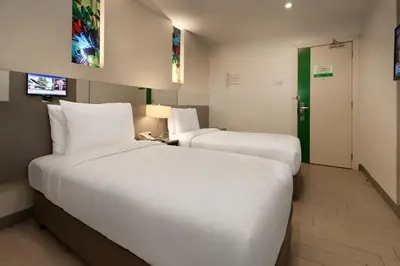 a hotel room with two beds and a television at Go Hotels Ortigas Center in Manila
