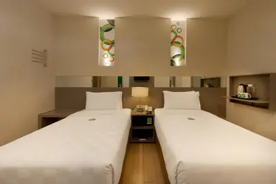 two beds in a hotel room with two beds sidx sidx sidx at Go Hotels Ortigas Center in Manila
