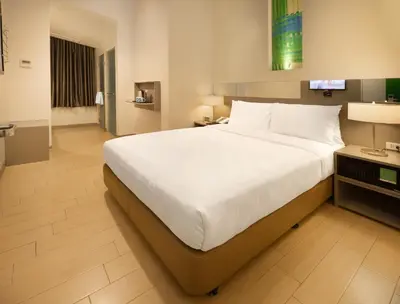 a bedroom with a large bed in a hotel room at Go Hotels Ortigas Center in Manila