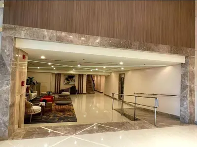 a lobby of a building with a staircase in it at High speed internet - Cozy 1BR fully Furnished in Manila
