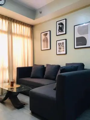 a living room with a couch and a coffee table at Long term Rental of 2 BR Condo @Malate, Manila (opp Robinson Place Mall) in Manila