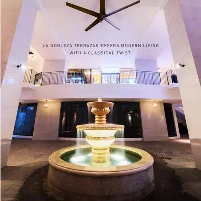 a fountain in the middle of a building with a clock at Long term Rental of 2 BR Condo @Malate, Manila (opp Robinson Place Mall) in Manila