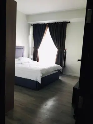 a bedroom with a bed and a large window at Long term Rental of 2 BR Condo @Malate, Manila (opp Robinson Place Mall) in Manila