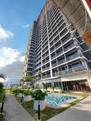 a large building with a swimming pool in front of it at Avery's Place at SMDC RED RES. in Manila