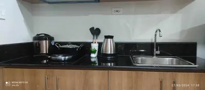 a kitchen with a sink and a counter top at Avery's Place at SMDC RED RES. in Manila