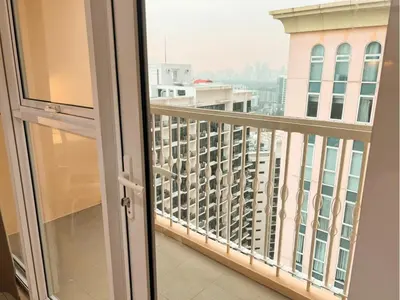 a balcony with a view of a city at Modern Condo At Venice Residences Bgc #vlrb29k in Manila