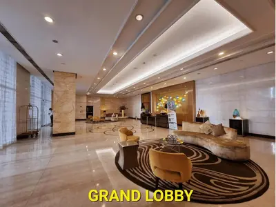 a lobby with a couch and chairs in a building at Modern Condo At Venice Residences Bgc #vlrb29k in Manila