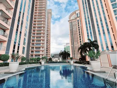 a swimming pool in a city with tall buildings at Modern Condo At Venice Residences Bgc #vlrb29k in Manila