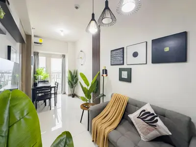 a living room with a couch and a table at GemstoneBR in SMDC Coast Residences in Manila