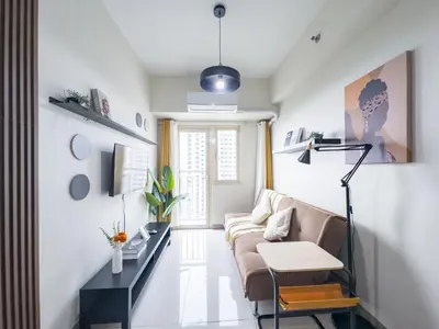 a living room with a couch and a table at GemstoneBR in SMDC Coast Residences in Manila