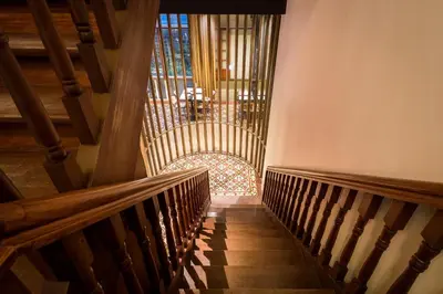 a staircase in a church with wooden stairs at The Henry Hotel Manila in Manila