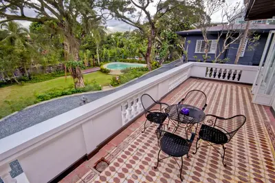 a patio with two chairs and a table on a balcony at The Henry Hotel Manila in Manila