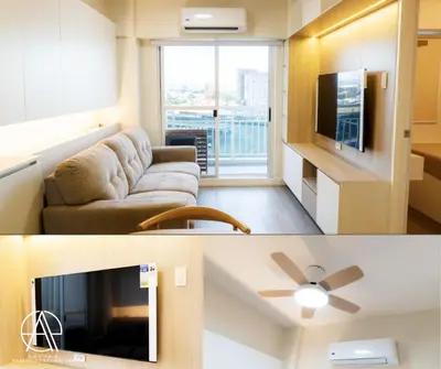 a living room with a couch and a flat screen tv at Casa Escudero in Manila