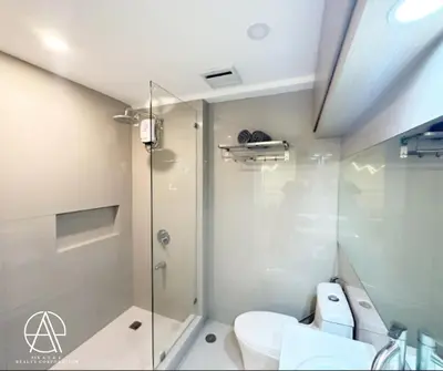 a bathroom with a glass shower and a toilet at Casa Escudero in Manila