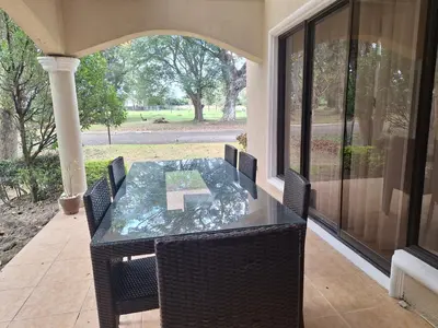 a glass table and chairs on a screened porch at La Dolce Vita Villa in Santa Rosa