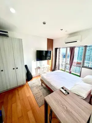 a bedroom with a bed and a tv and a table at Acqua Private Residences - Iguazu Tower 36th flr Mandaluyong - Makati in Manila