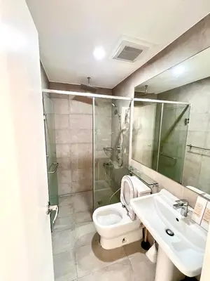 a bathroom with a toilet and a sink and a shower at Acqua Private Residences - Iguazu Tower 36th flr Mandaluyong - Makati in Manila