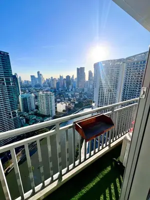a chair on a balcony with a view of the city at Acqua Private Residences - Iguazu Tower 36th flr Mandaluyong - Makati in Manila