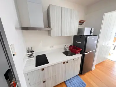 a small kitchen with a sink and a refrigerator at Acqua Private Residences - Iguazu Tower 36th flr Mandaluyong - Makati in Manila