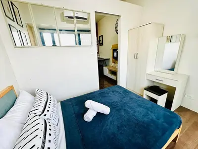 a bedroom with a bed with two rolled towels on it at Mon ciel suite Spacious 1BR Air Residence SMDC in Manila