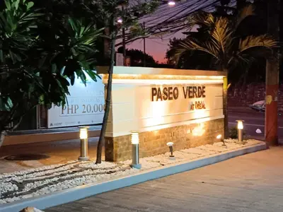 a sign for a paseo vive event at night at Paseo Verde Condominium in Manila
