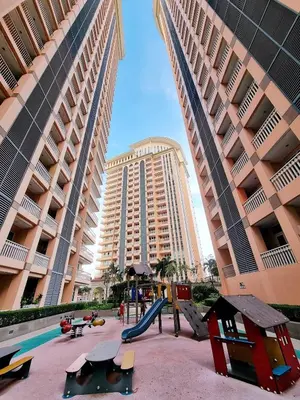 a playground in front of a large building at Luxury BGC Condo, Venice Grand Canal #vlrtc5h in Manila