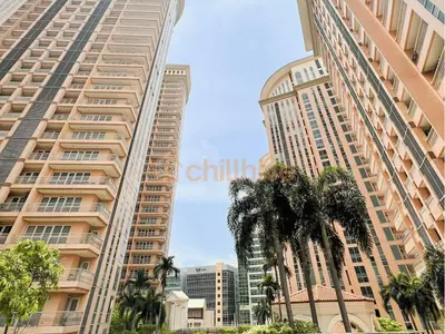two tall buildings in a city with palm trees at Luxury BGC Condo, Venice Grand Canal #vlrtc5h in Manila