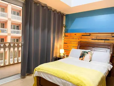 a bedroom with a bed and a large window at Elegant Condo Beside Venice Grand Canal #vlra23j in Manila