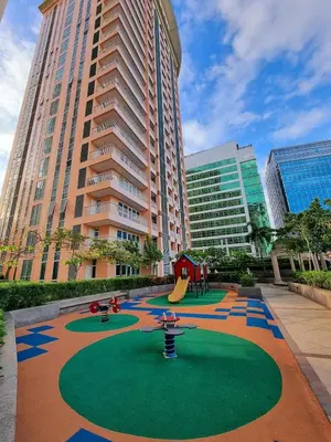 a playground in the middle of a city with tall buildings at Elegant Condo Beside Venice Grand Canal #vlra23j in Manila