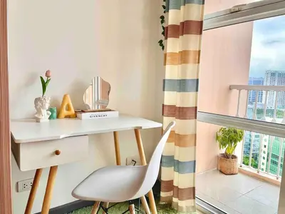 a desk and a chair in a room with a window at Luxury Bgc Condo Near Venice Mall #vlra22e in Manila