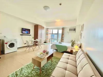 a living room with a couch and a living room with at Luxury Bgc Condo Near Venice Mall #vlra22e in Manila