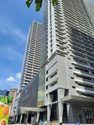 a tall building with a billboard on the side of it at SMDC Fame Marcelle's Place near Mega Mall in Manila