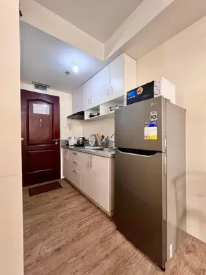a kitchen with a stainless steel refrigerator and a sink at Condo in Silang Fullerton Suites - near tagaytay and nuvali in Silang