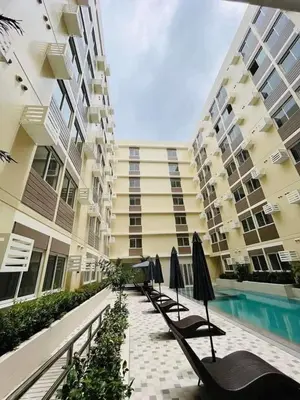 a row of chairs and umbrellas in front of a building at Condo in Silang Fullerton Suites - near tagaytay and nuvali in Silang