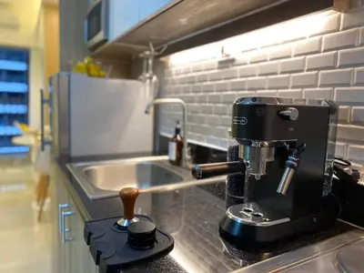a coffee maker sitting on a counter in a kitchen at 1BR w/ Balcony near Megamall: The Admiral‘s Lounge in Manila
