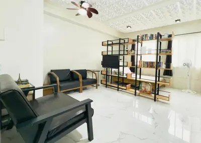 a living room with a couch and a table and a tv at Modern Simplicity: Cozy @Nuvali in Pitland