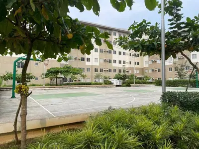 a tennis court in front of a building at Modern Simplicity: Cozy @Nuvali in Pitland