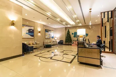 a man sitting at a desk in a lobby at Studio at Venice Mall, near Airport, BGC & Makati in Manila