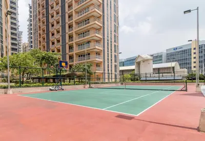 a tennis court in a city with tall buildings at Studio at Venice Mall, near Airport, BGC & Makati in Manila